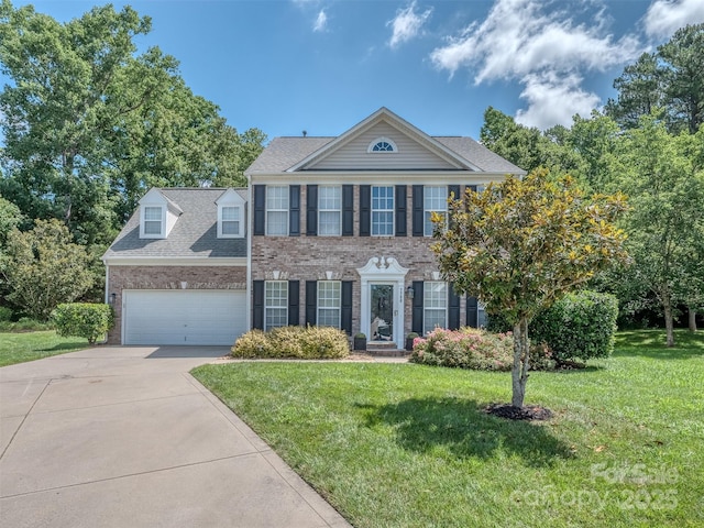 7700 Antique Cir, Waxhaw, NC 28173 - view of front facade featuring concrete driveway, brick siding, a front yard, and a garage