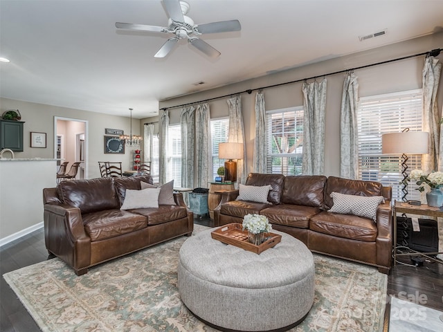 7700 Antique Cir, Waxhaw, NC 28173 - living room with plenty of natural light, wood finished floors, a ceiling fan, and a chandelier
