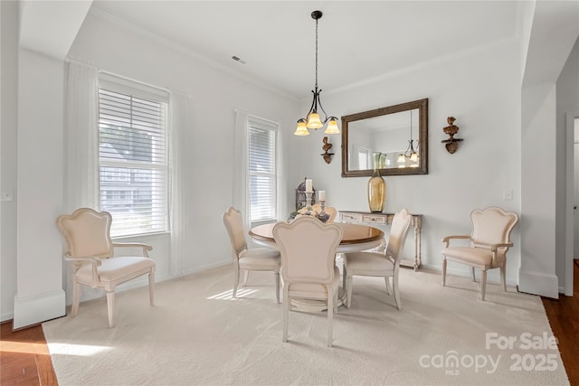 2399 Ashbourne Pl SE, Concord, NC 28025 - dining space with a chandelier, ornamental molding, and carpet