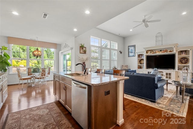 2399 Ashbourne Pl SE, Concord, NC 28025 - kitchen with dishwasher, dark wood finished floors, light stone countertops, a center island with sink, and recessed lighting