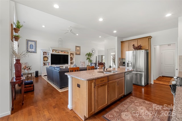 2399 Ashbourne Pl SE, Concord, NC 28025 - kitchen featuring stainless steel appliances, a ceiling fan, light stone countertops, dark wood-style floors, and open floor plan