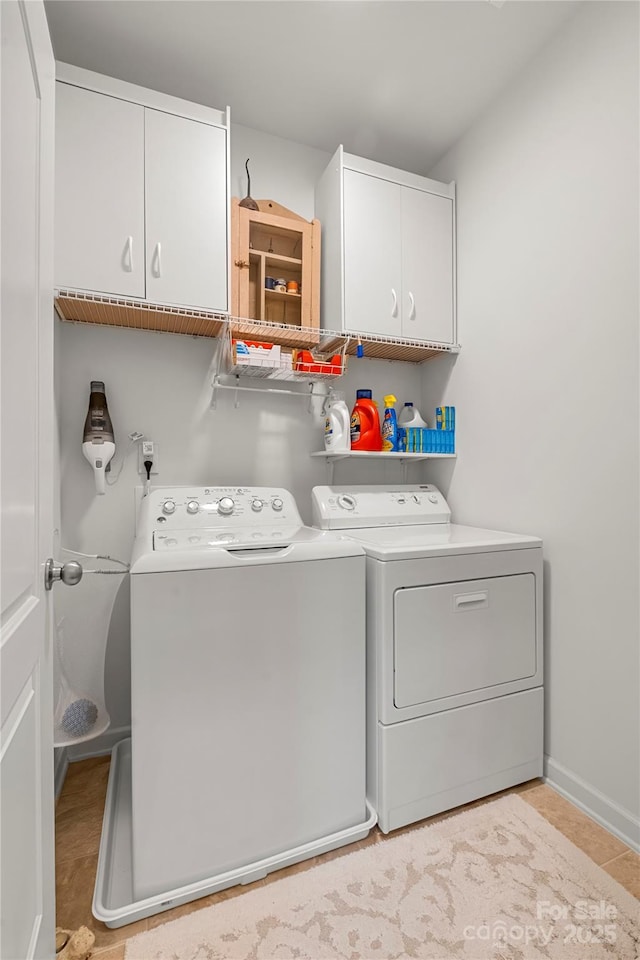 2399 Ashbourne Pl SE, Concord, NC 28025 - washroom featuring cabinet space, separate washer and dryer, and light tile patterned floors