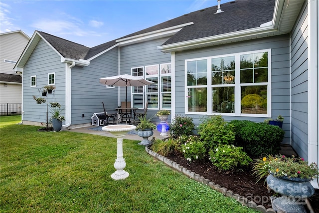 2399 Ashbourne Pl SE, Concord, NC 28025 - back of property with a yard, a shingled roof, and a patio area