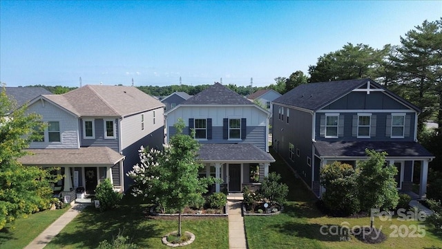 11965 Hambright Rd, Huntersville, NC 28078 - view of front of property with board and batten siding, a front yard, covered porch, and a shingled roof