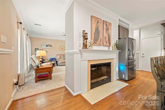 162 Castles Gate Dr, Mooresville, NC 28117 - living room featuring ornamental molding, light wood-style floors, and a fireplace with flush hearth