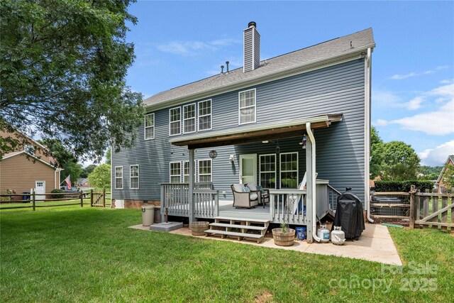 162 Castles Gate Dr, Mooresville, NC 28117 - back of house featuring a fenced backyard, a chimney, and a wooden deck