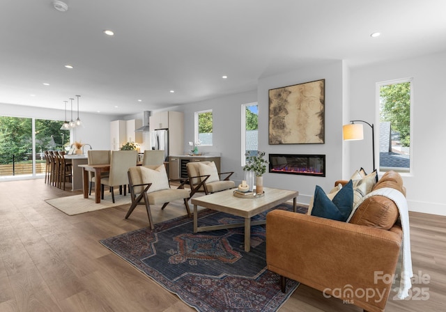 209 Keswick Ave, Charlotte, NC 28206 - living room featuring light wood finished floors, recessed lighting, and a glass covered fireplace