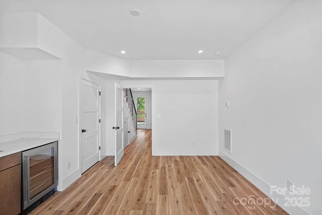 209 Keswick Ave, Charlotte, NC 28206 - empty room with beverage cooler, light wood-style flooring, and recessed lighting