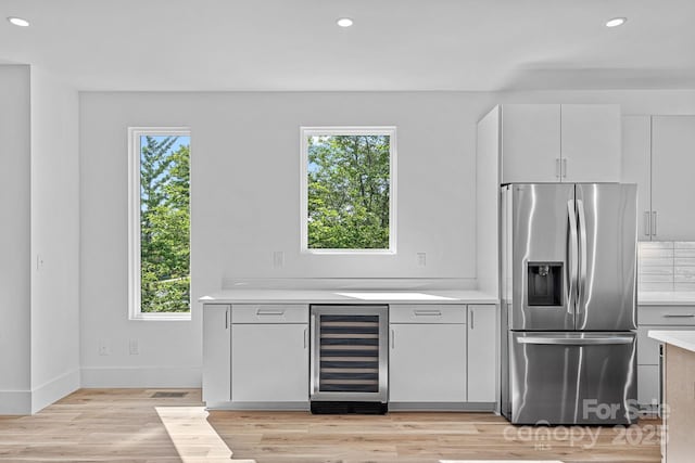 209 Keswick Ave, Charlotte, NC 28206 - kitchen featuring stainless steel fridge, beverage cooler, light countertops, light wood-type flooring, and recessed lighting