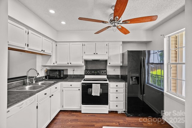 218 Water Oak Dr, Pineville, NC 28134 - kitchen featuring black appliances, dark countertops, dark wood-style flooring, a textured ceiling, and white cabinets