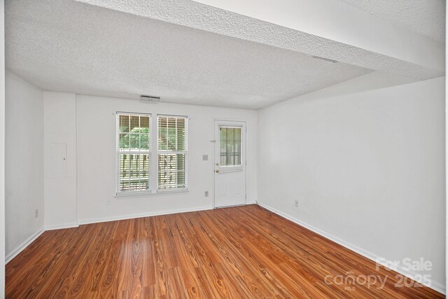 218 Water Oak Dr, Pineville, NC 28134 - unfurnished room with a textured ceiling and wood finished floors