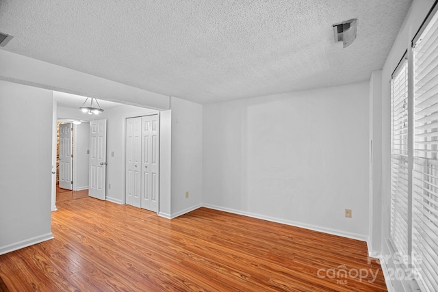 218 Water Oak Dr, Pineville, NC 28134 - unfurnished bedroom with a textured ceiling and wood finished floors