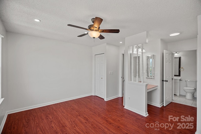 218 Water Oak Dr, Pineville, NC 28134 - unfurnished bedroom featuring wood finished floors, a textured ceiling, ensuite bath, recessed lighting, and ceiling fan
