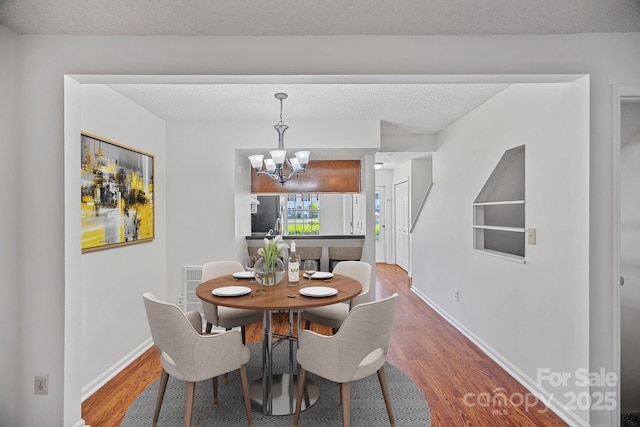 218 Water Oak Dr, Pineville, NC 28134 - dining area with a chandelier and wood finished floors
