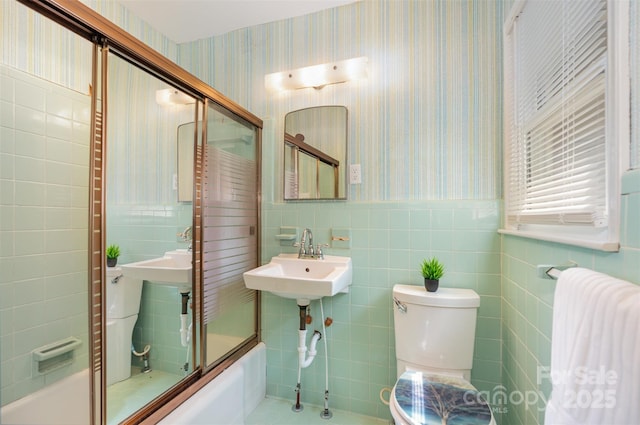 1925 Montclair Ave, Gastonia, NC 28054 - bathroom featuring wallpapered walls, tile walls, a wainscoted wall, a bathtub, and radiator heating unit