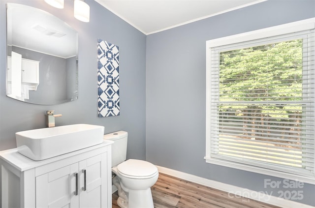 1925 Montclair Ave, Gastonia, NC 28054 - half bath featuring wood finished floors, vanity, and crown molding