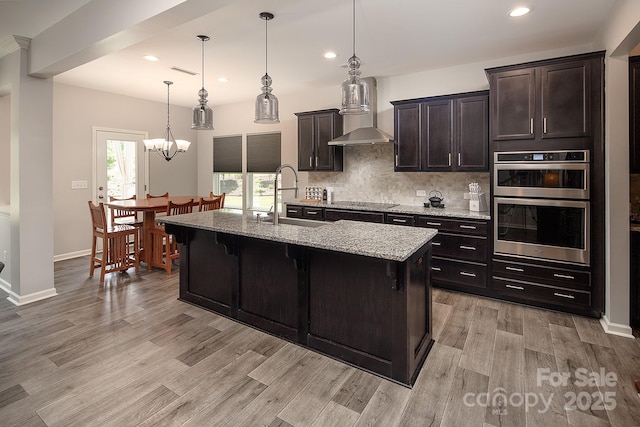 171 Old Harbor Dr, Mount Gilead, NC 27306 - kitchen with double oven, light wood-type flooring, recessed lighting, backsplash, and light stone counters