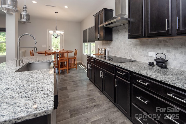 171 Old Harbor Dr, Mount Gilead, NC 27306 - kitchen with wall chimney exhaust hood, recessed lighting, a chandelier, light wood-style flooring, and black electric stovetop