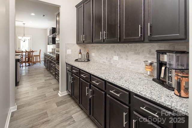 171 Old Harbor Dr, Mount Gilead, NC 27306 - kitchen featuring tasteful backsplash, light stone counters, light wood-style flooring, and recessed lighting
