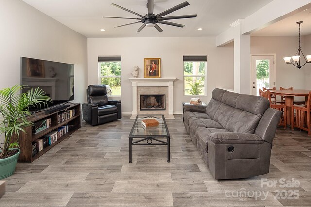171 Old Harbor Dr, Mount Gilead, NC 27306 - living area with ceiling fan, a fireplace, light wood-type flooring, recessed lighting, and a chandelier