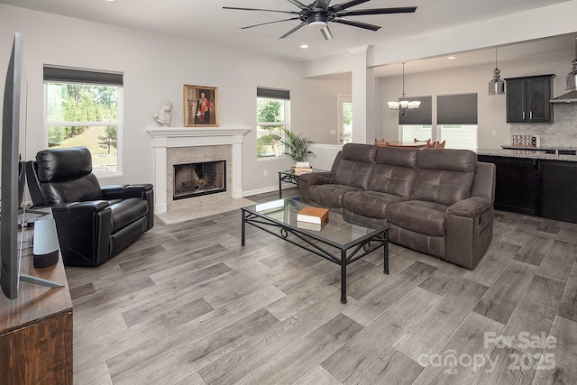 171 Old Harbor Dr, Mount Gilead, NC 27306 - living room with ceiling fan, light wood-type flooring, a fireplace with flush hearth, recessed lighting, and a chandelier