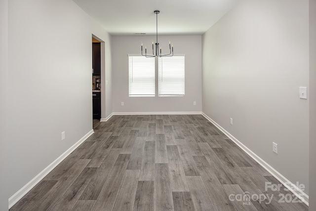 171 Old Harbor Dr, Mount Gilead, NC 27306 - unfurnished dining area featuring a chandelier and wood finished floors