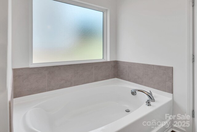 171 Old Harbor Dr, Mount Gilead, NC 27306 - bathroom featuring healthy amount of natural light and a bath
