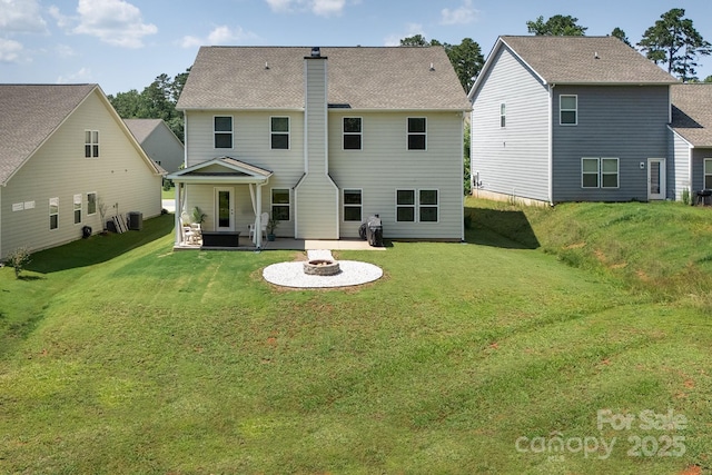 171 Old Harbor Dr, Mount Gilead, NC 27306 - back of property featuring a fire pit, a patio area, a chimney, and a lawn