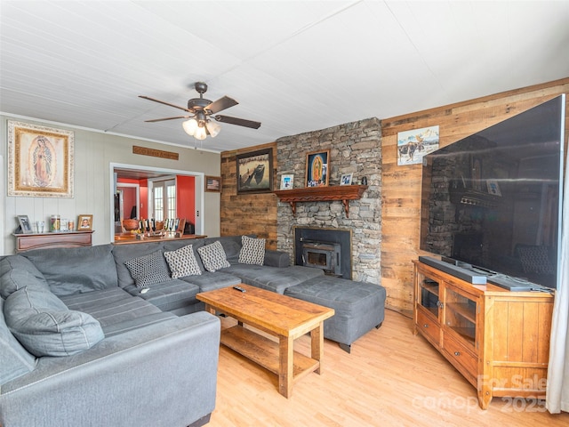 157 Evergreen Cir, Waynesville, NC 28786 - living area featuring wooden walls, ceiling fan, light wood-type flooring, and a stone fireplace