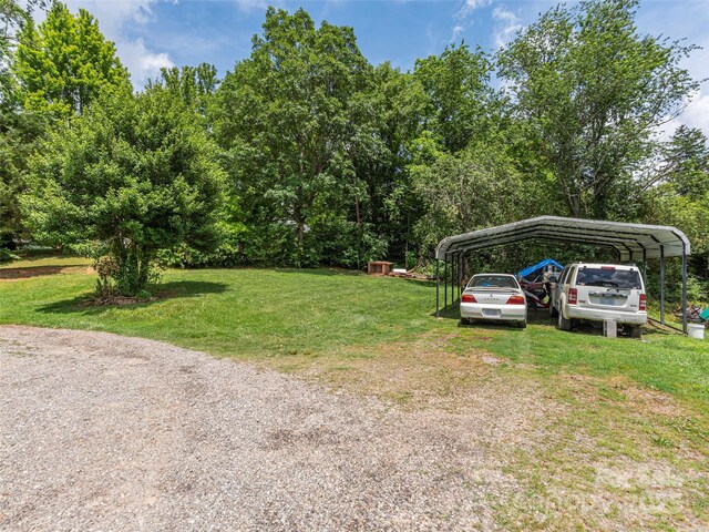 157 Evergreen Cir, Waynesville, NC 28786 - view of grassy yard featuring a carport and driveway