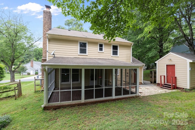 906 Wishing Well Ln, Charlotte, NC 28270 - rear view of house with a chimney, a sunroom, a storage shed, and a shingled roof