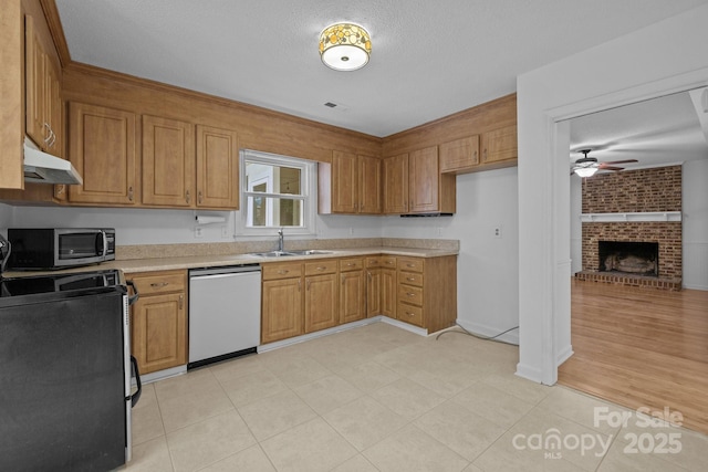 906 Wishing Well Ln, Charlotte, NC 28270 - kitchen featuring stainless steel appliances, under cabinet range hood, light countertops, a ceiling fan, and brown cabinets