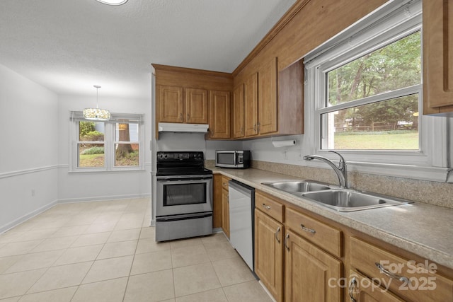 906 Wishing Well Ln, Charlotte, NC 28270 - kitchen with stainless steel appliances, under cabinet range hood, light countertops, light tile patterned floors, and a textured ceiling