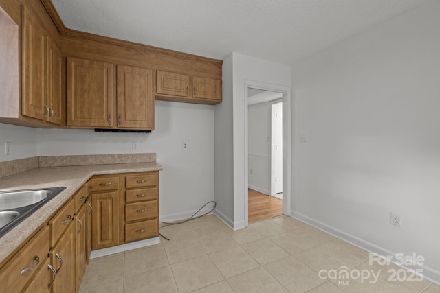 906 Wishing Well Ln, Charlotte, NC 28270 - kitchen with brown cabinets, light countertops, and light tile patterned flooring