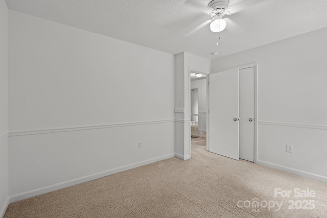 906 Wishing Well Ln, Charlotte, NC 28270 - unfurnished bedroom featuring carpet, a closet, a ceiling fan, and a textured ceiling