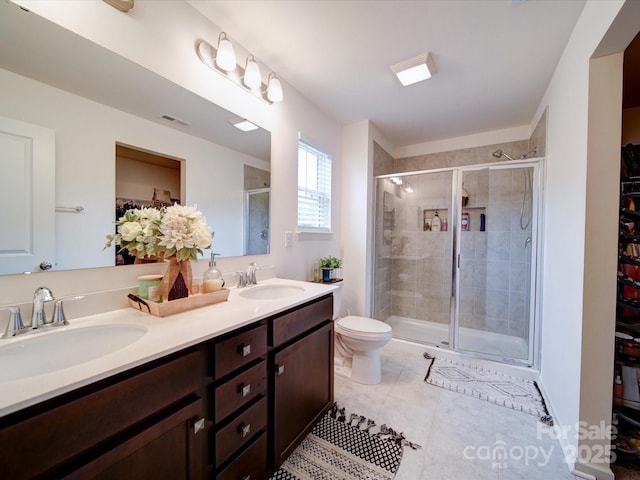 5121 Arbordale Way, Mount Holly, NC 28120 - bathroom featuring double vanity, tile patterned floors, a stall shower, and a walk in closet