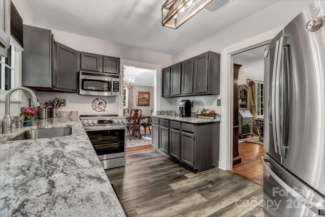 60 Meeks Rd, Black Mountain, NC 28711 - kitchen with stainless steel appliances, a chandelier, light stone counters, and dark wood finished floors