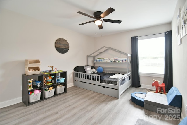 339 Brown Rd, China Grove, NC 28023 - bedroom with wood finished floors, a crib, and a ceiling fan