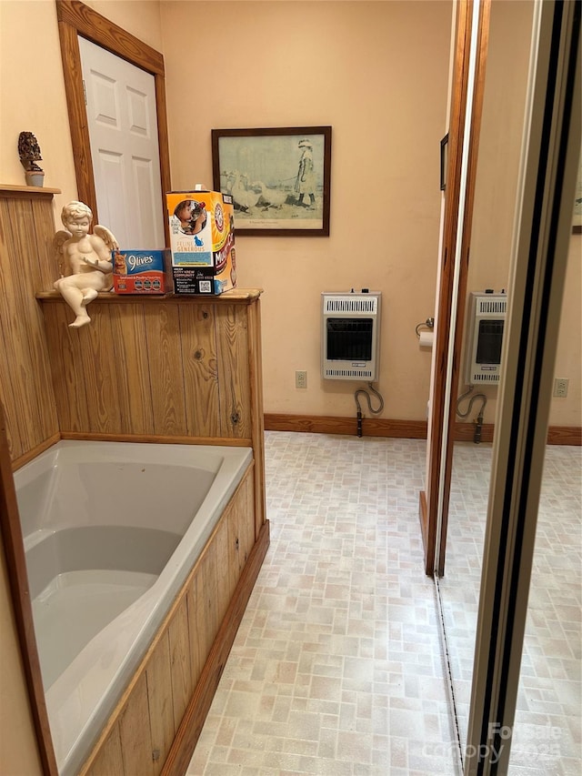 687 Willow Creek Rd, Leicester, NC 28748 - full bathroom featuring heating unit, brick patterned floors, and a bath