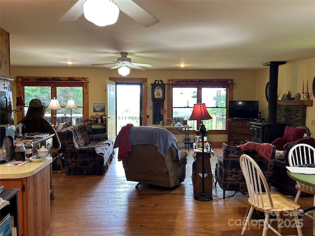 687 Willow Creek Rd, Leicester, NC 28748 - living room with a ceiling fan, a wood stove, and wood finished floors