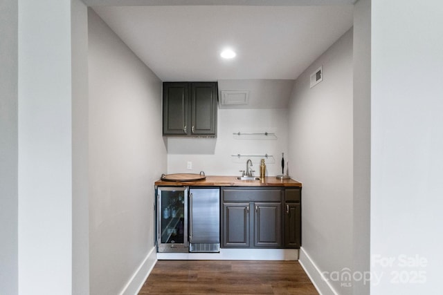 1032 Spyglass Ln, Waxhaw, NC 28173 - indoor wet bar with wine cooler, dark wood finished floors, and recessed lighting