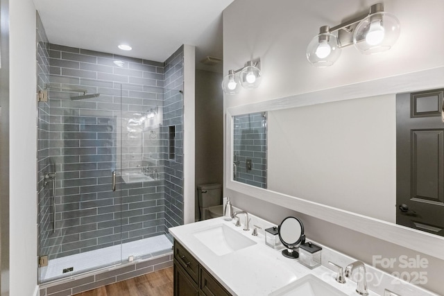 1032 Spyglass Ln, Waxhaw, NC 28173 - bathroom with a stall shower, double vanity, and wood finished floors