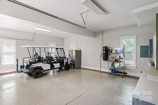 1032 Spyglass Ln, Waxhaw, NC 28173 - garage featuring electric panel and stainless steel fridge with ice dispenser