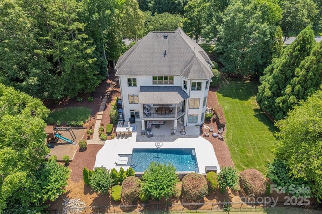 1032 Spyglass Ln, Waxhaw, NC 28173 - back of property featuring a patio, an outdoor pool, stairs, stucco siding, and a shingled roof
