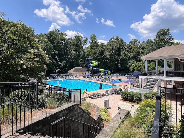 1032 Spyglass Ln, Waxhaw, NC 28173 - community pool featuring a water slide and a patio