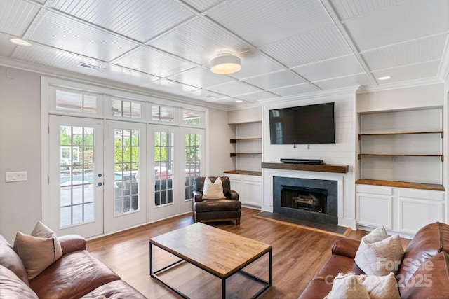 1032 Spyglass Ln, Waxhaw, NC 28173 - living area featuring plenty of natural light, french doors, wood finished floors, ornamental molding, and coffered ceiling