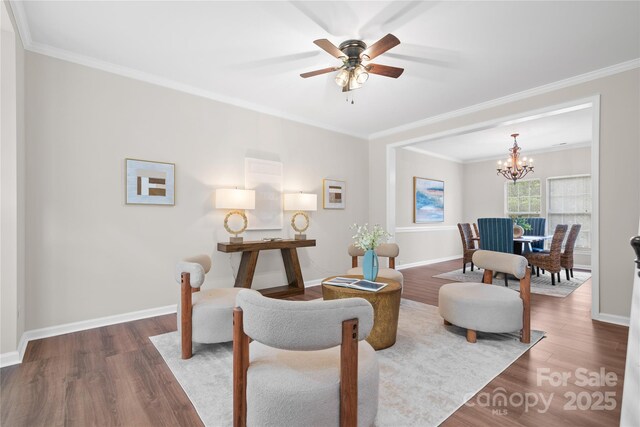 6803 Augustine Way, Charlotte, NC 28270 - living area featuring wood finished floors, crown molding, a chandelier, and a ceiling fan