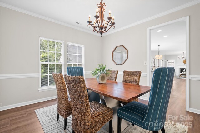 6803 Augustine Way, Charlotte, NC 28270 - dining space with a chandelier, plenty of natural light, wood finished floors, ornamental molding, and recessed lighting