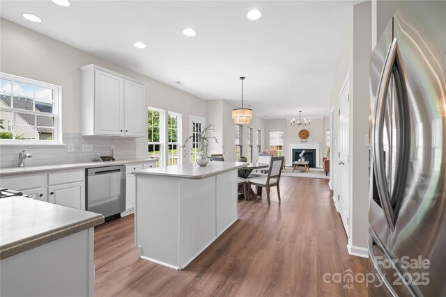6803 Augustine Way, Charlotte, NC 28270 - kitchen with appliances with stainless steel finishes, wood finished floors, white cabinets, tasteful backsplash, and recessed lighting