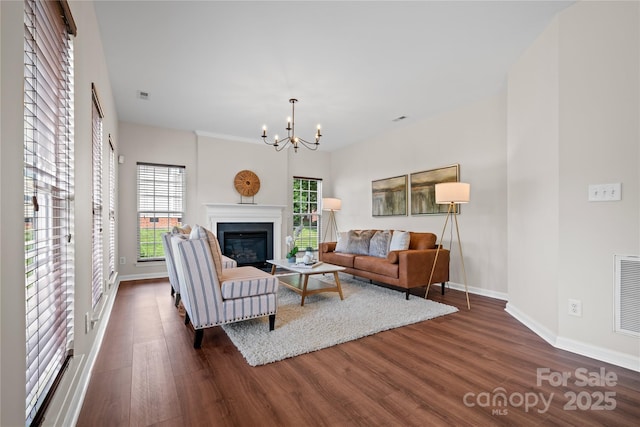 6803 Augustine Way, Charlotte, NC 28270 - living room with dark wood-style floors, a chandelier, and a glass covered fireplace